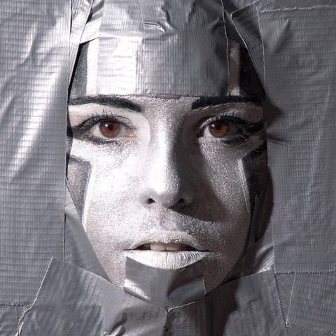 Woman’s face masked with silver duct tape