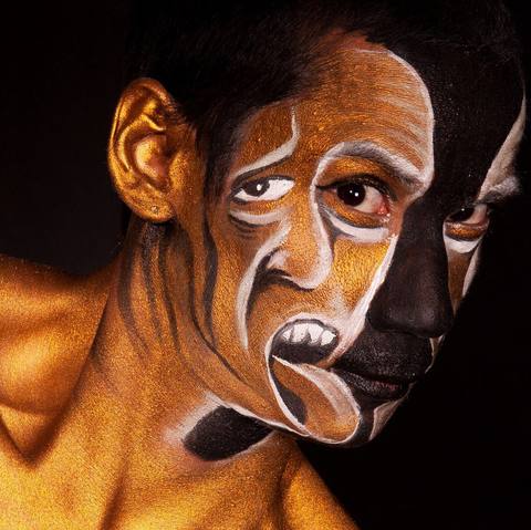 Face painting: a second face with a painted mouth, against black